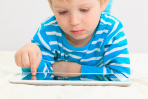 Little boy with touch pad